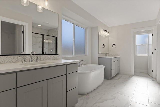 bathroom featuring vanity, an enclosed shower, and backsplash