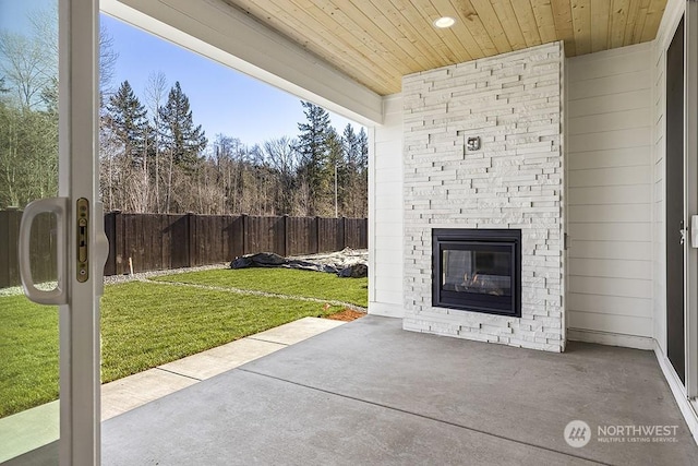 view of patio featuring an outdoor stone fireplace