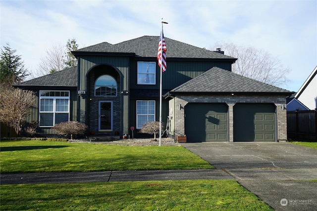 view of front of house with a front yard and a garage