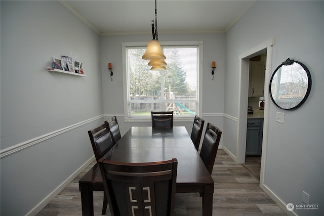 dining area with dark hardwood / wood-style flooring and ornamental molding