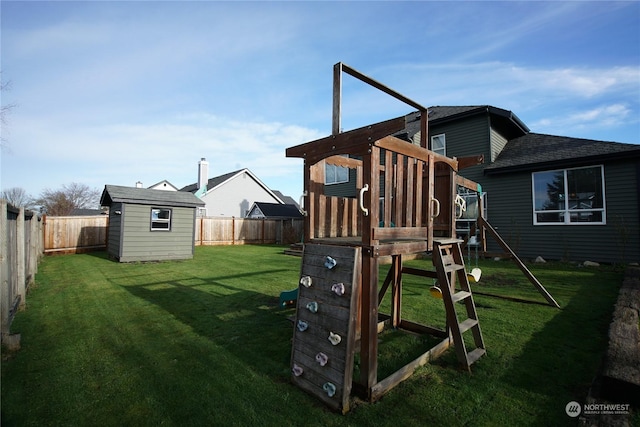 view of playground featuring a lawn and a storage unit