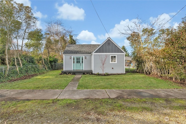 bungalow-style home featuring a front lawn