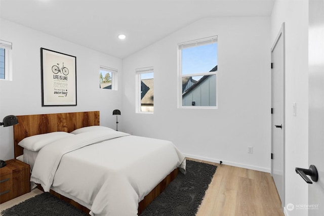 bedroom featuring wood-type flooring and vaulted ceiling