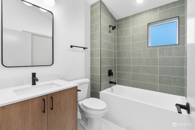 full bathroom featuring toilet, vanity, and tiled shower / bath