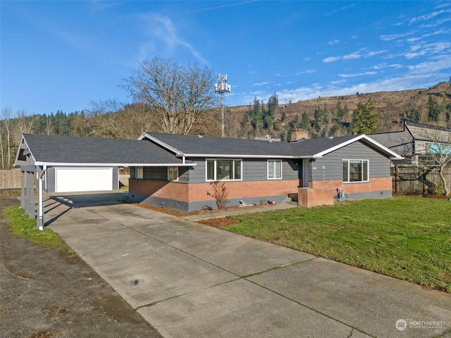 ranch-style home with a front yard, a mountain view, and a garage