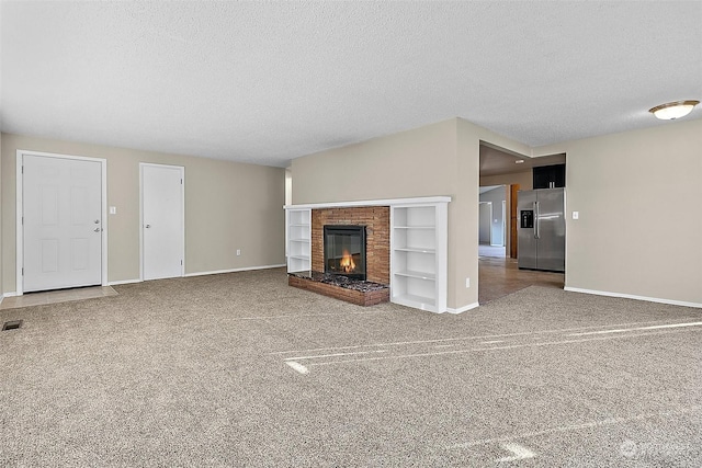 unfurnished living room with a fireplace and a textured ceiling