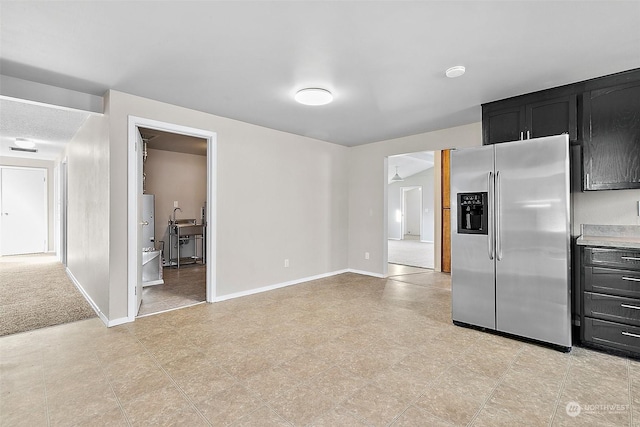 kitchen featuring stainless steel refrigerator with ice dispenser