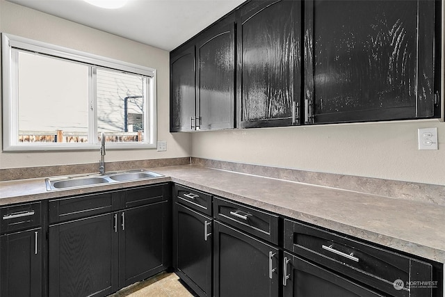 kitchen featuring light tile patterned flooring and sink