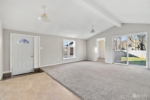 foyer entrance featuring vaulted ceiling with beams and a textured ceiling