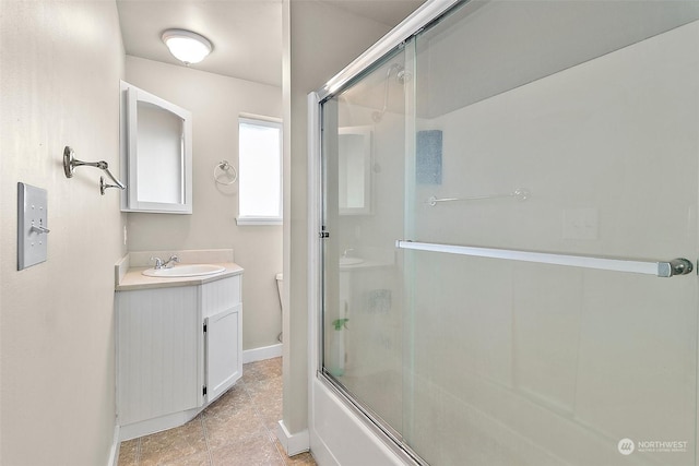 bathroom with vanity and bath / shower combo with glass door