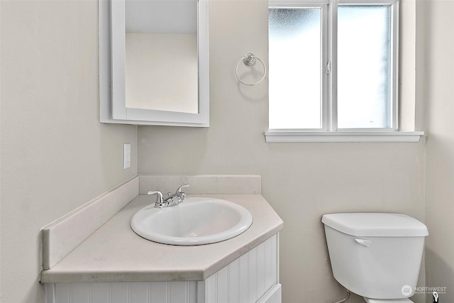 bathroom featuring vanity and toilet