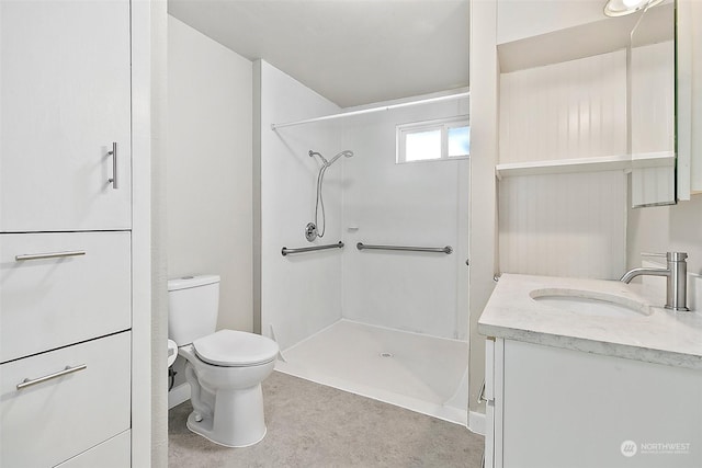 bathroom featuring vanity, toilet, and walk in shower