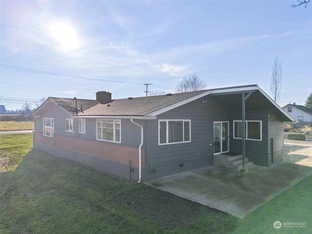 rear view of property featuring a yard and a patio