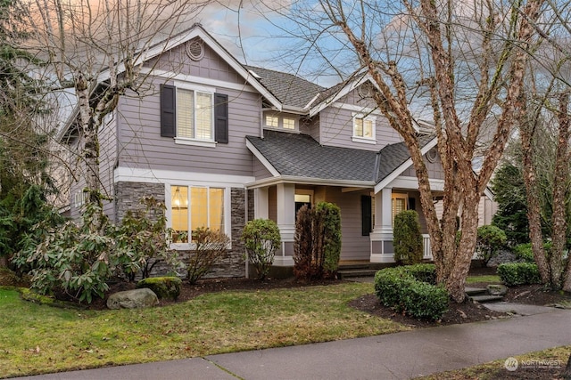 craftsman-style home with a front yard