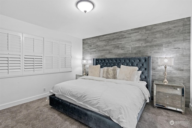 bedroom with carpet flooring and wood walls