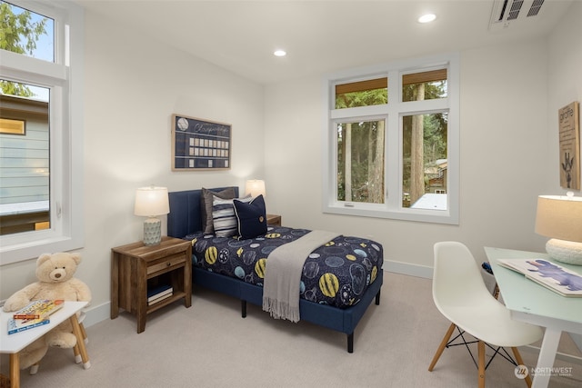 carpeted bedroom featuring multiple windows