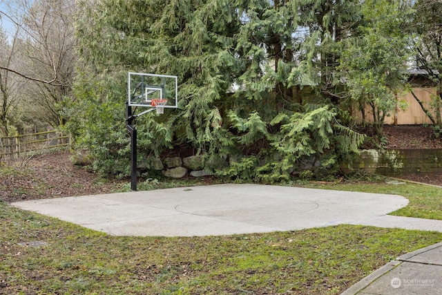 view of basketball court featuring a yard