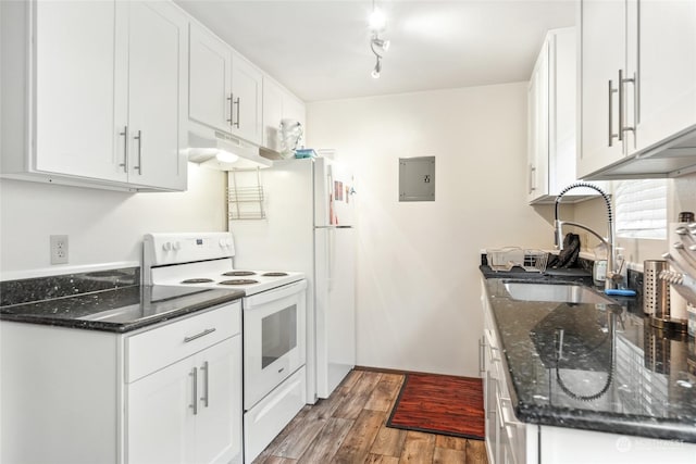 kitchen featuring white electric range oven, sink, dark stone counters, hardwood / wood-style floors, and white cabinets