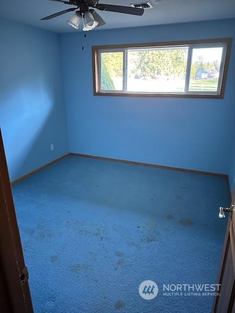 unfurnished room featuring ceiling fan and carpet floors