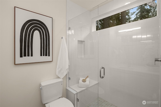 bathroom featuring an enclosed shower and toilet