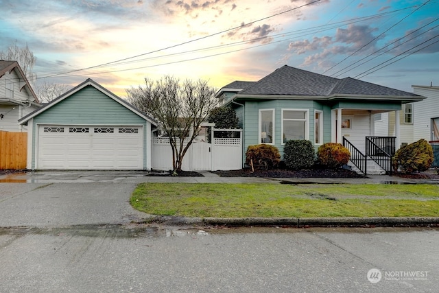 view of front of house with a garage and a lawn