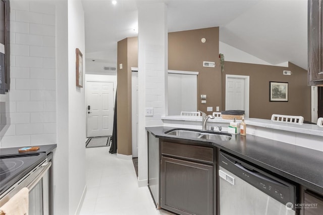 kitchen featuring dishwasher, vaulted ceiling, light tile patterned floors, dark brown cabinetry, and sink