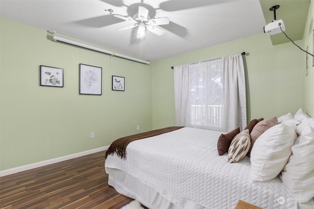 bedroom with ceiling fan and dark hardwood / wood-style floors