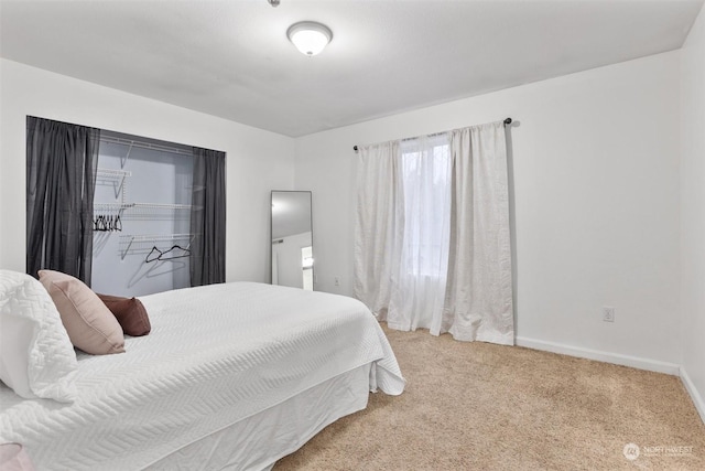 bedroom featuring light carpet