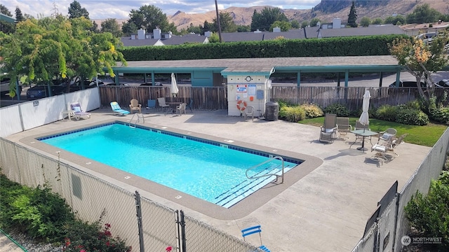 view of pool with a patio area and a mountain view