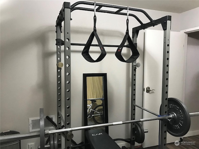 workout area featuring hardwood / wood-style floors