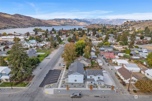 aerial view featuring a water and mountain view