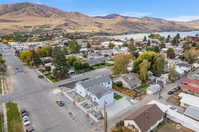 aerial view featuring a water and mountain view