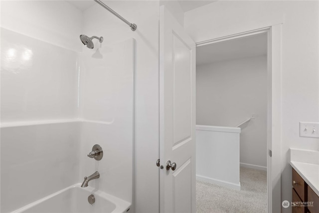 bathroom featuring washtub / shower combination and vanity