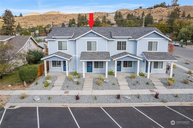 view of front property featuring a mountain view and covered porch