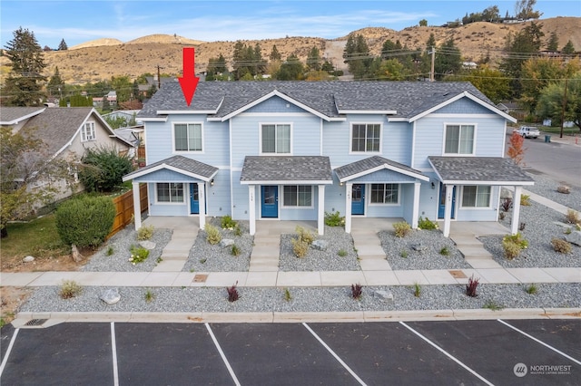 front facade featuring a mountain view and covered porch