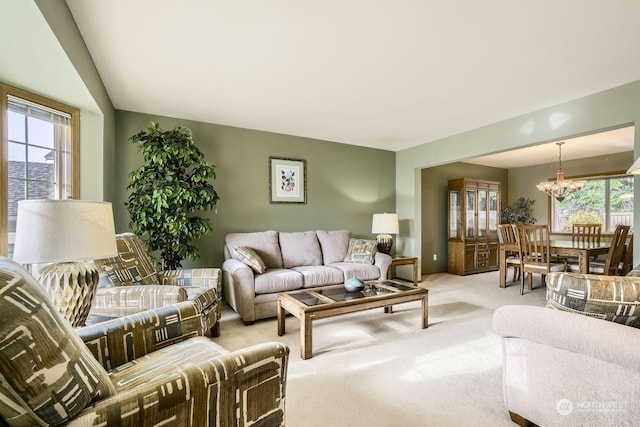 living room featuring an inviting chandelier and carpet floors