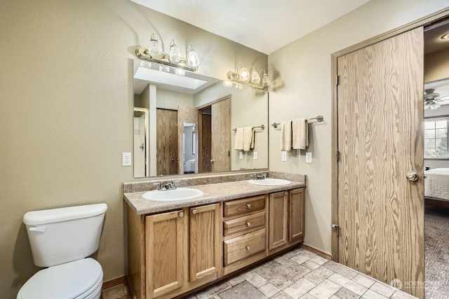 bathroom with ceiling fan, vanity, and toilet