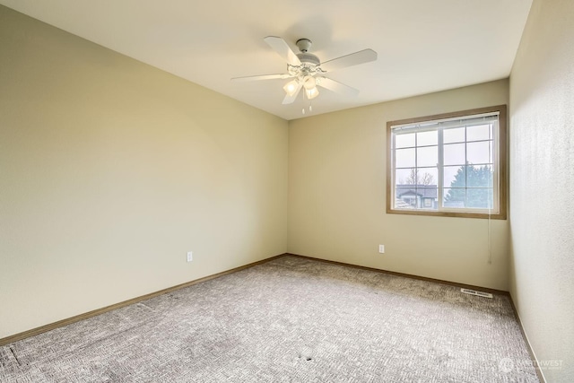 spare room with ceiling fan and carpet flooring