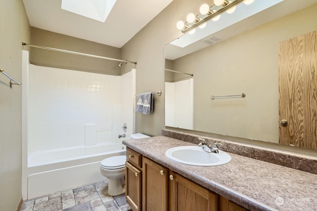 full bathroom with toilet, shower / tub combination, vanity, and a skylight