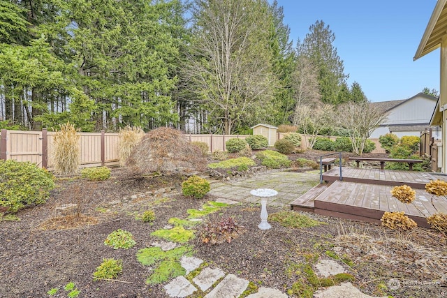 view of yard with a wooden deck and a shed