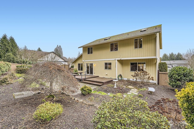 back of property featuring a wooden deck