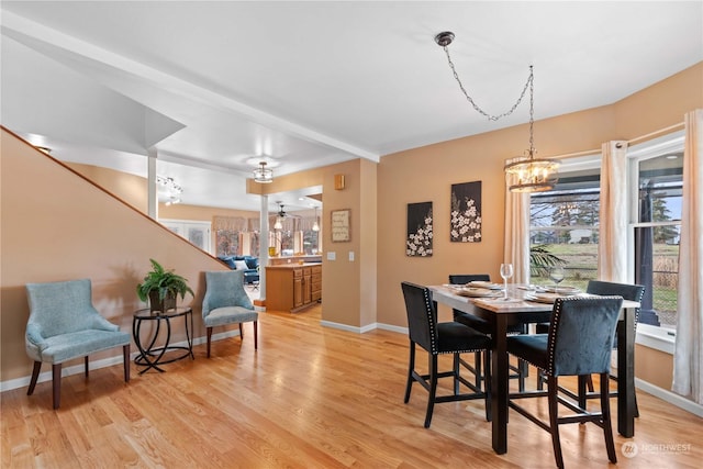 dining space with an inviting chandelier and light hardwood / wood-style floors