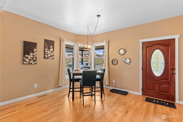 dining room featuring a chandelier and light hardwood / wood-style flooring