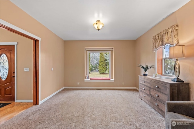 living area featuring light carpet