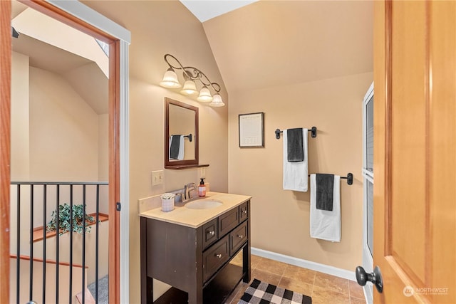 bathroom with vanity and vaulted ceiling