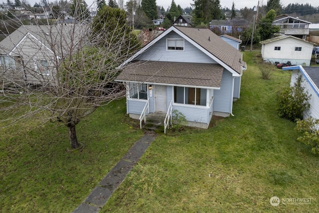 bungalow-style house with a front lawn