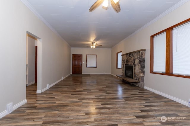 unfurnished living room with dark hardwood / wood-style flooring, a stone fireplace, ceiling fan, and ornamental molding