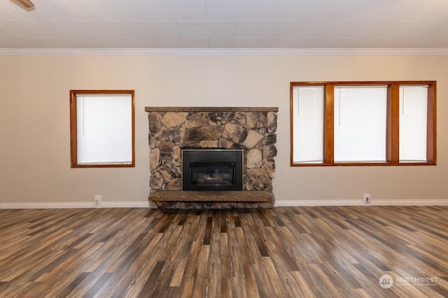 unfurnished living room featuring a fireplace, dark wood-type flooring, and ornamental molding