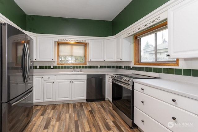 kitchen featuring white cabinetry, stainless steel electric range oven, black dishwasher, dark hardwood / wood-style floors, and fridge