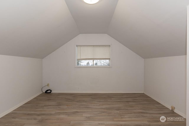 bonus room featuring lofted ceiling and light wood-type flooring